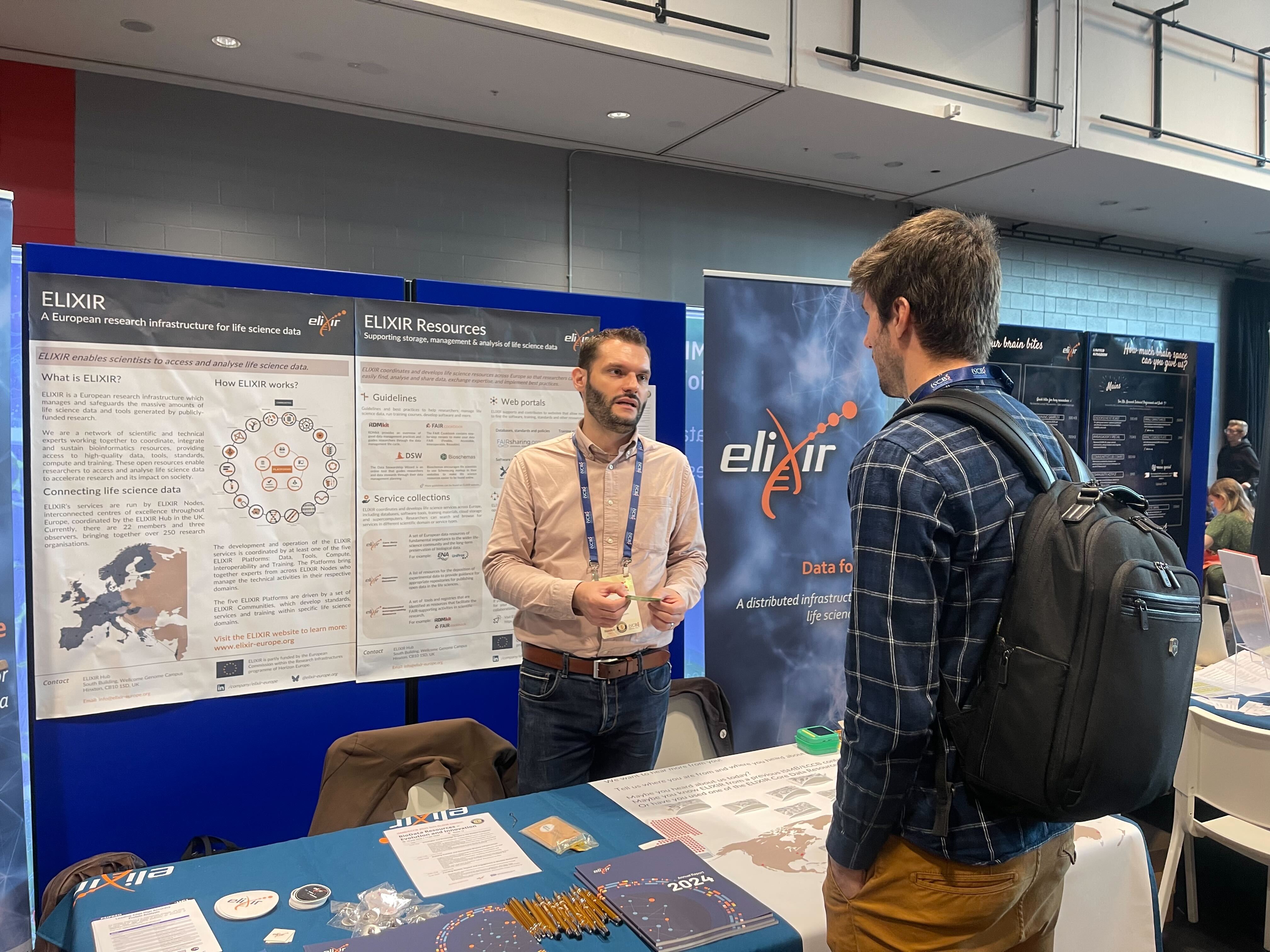 ELIXIR staff talking to ISMB/ECCB participant